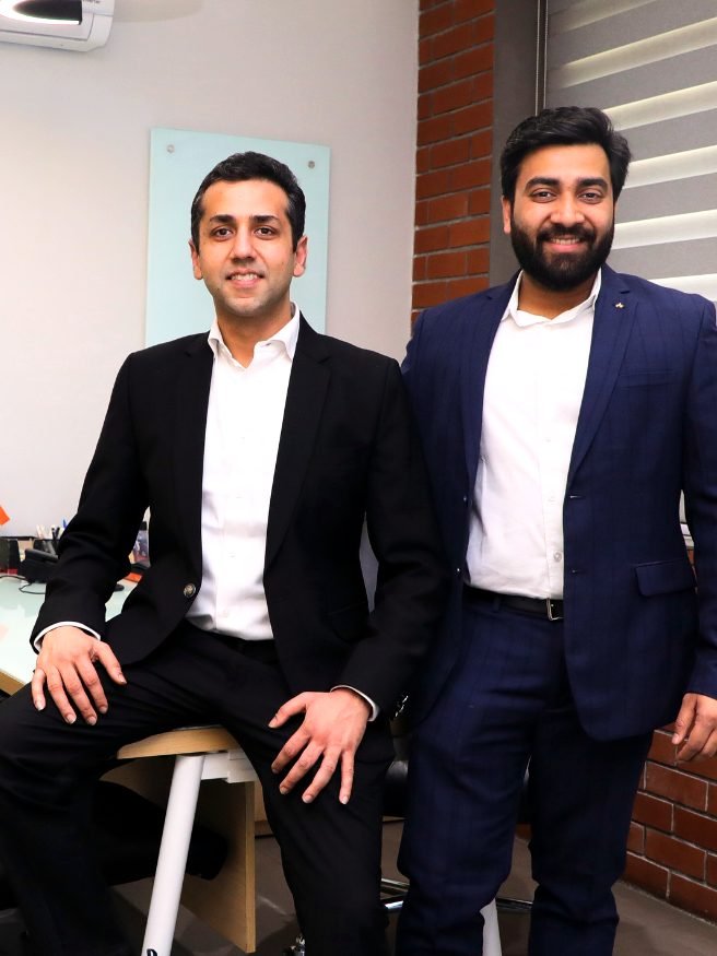 Two of the firm’s advisers at a desk in the Delhi office