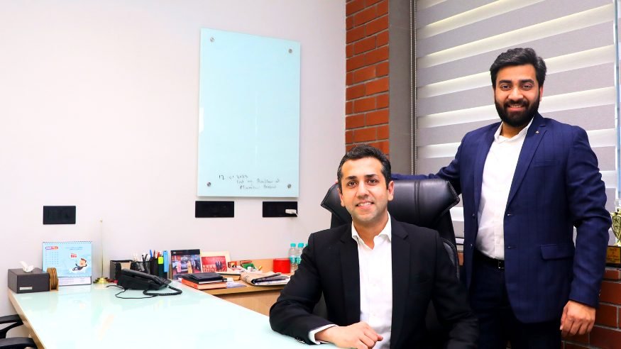 Two of the firm’s advisers at the glass desk in the Delhi office
