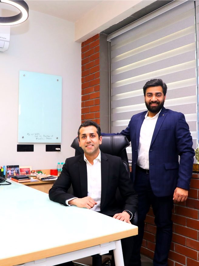 Two of the firm’s advisers at the glass desk in the Delhi office